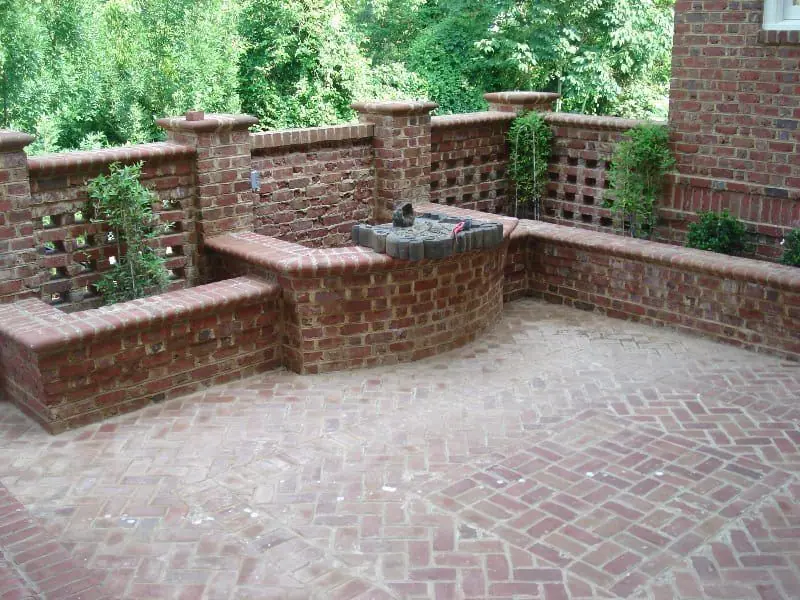 Herringbone brick courtyard with brick seat walls and lattice brick piers