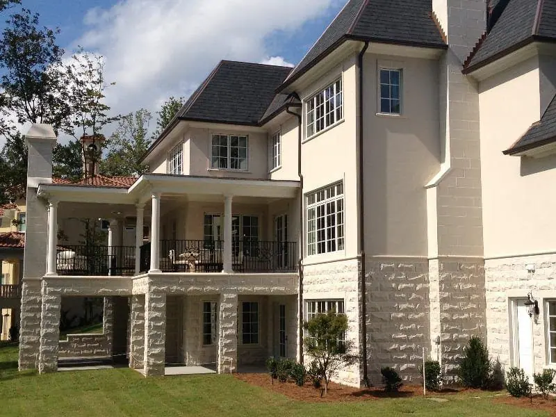 Rusticated stone base and piers under a two-story rear porch